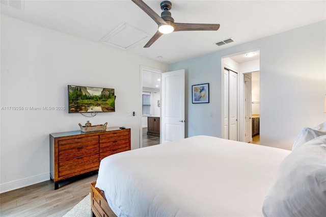 bedroom featuring ensuite bathroom, a closet, ceiling fan, and light hardwood / wood-style floors