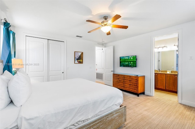 bedroom with ceiling fan, connected bathroom, and a closet