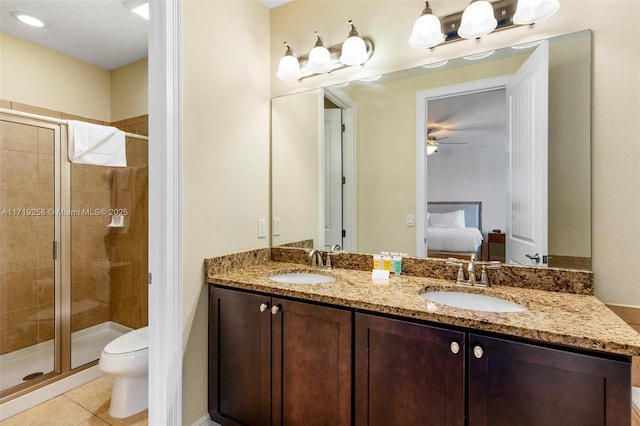 bathroom with an enclosed shower, vanity, ceiling fan, tile patterned flooring, and toilet