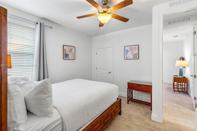 bedroom featuring multiple windows and ceiling fan