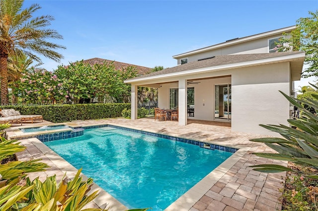 view of pool with an in ground hot tub, a patio, and ceiling fan