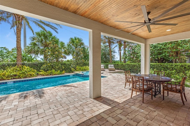 view of swimming pool featuring an in ground hot tub, ceiling fan, and a patio