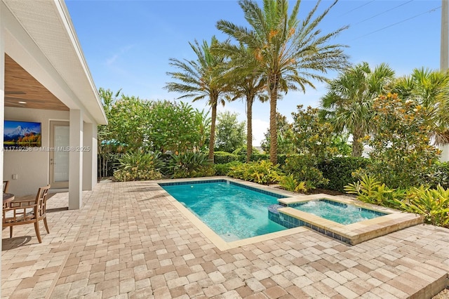 view of swimming pool featuring an in ground hot tub and a patio