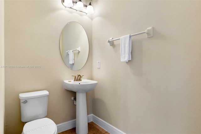 bathroom featuring tile patterned floors, sink, and toilet