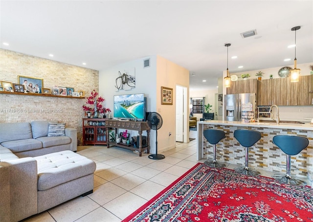 living room with light tile patterned floors and sink