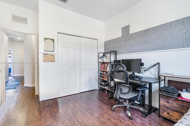 office with a high ceiling and dark hardwood / wood-style floors