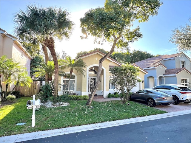 mediterranean / spanish-style home featuring a front lawn