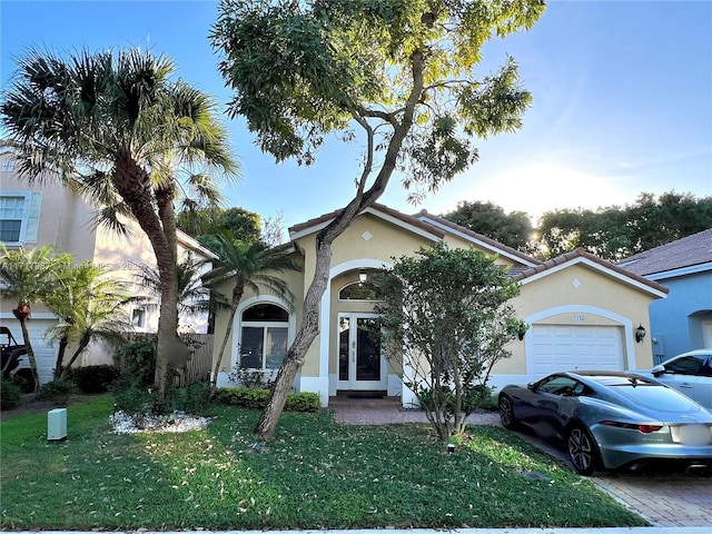 view of front of home featuring a garage and a front lawn