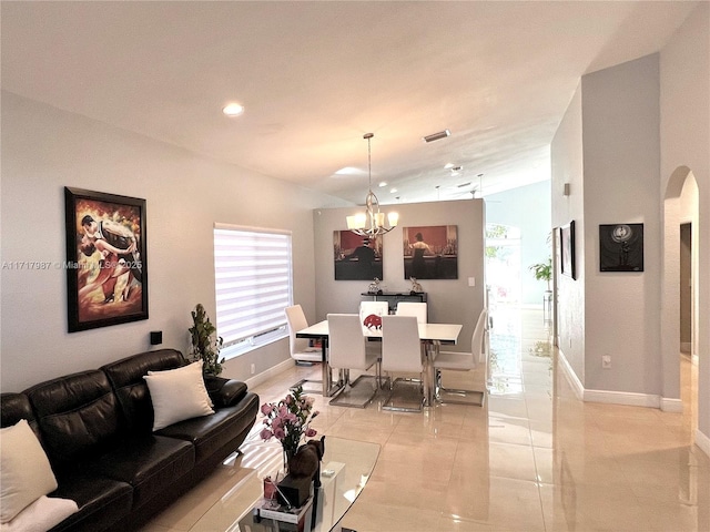 tiled living room featuring a chandelier