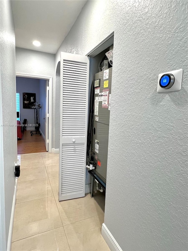 corridor featuring light tile patterned floors and heating unit