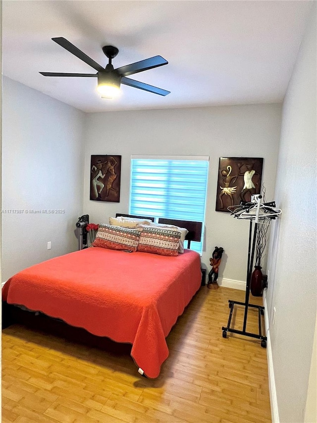 bedroom with ceiling fan and light hardwood / wood-style flooring