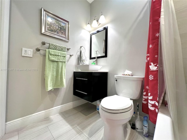 bathroom featuring vanity, a shower with shower curtain, and toilet