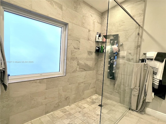 bathroom with tiled shower