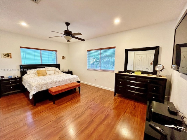 bedroom with ceiling fan and hardwood / wood-style floors