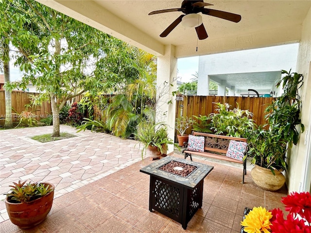 view of patio / terrace with ceiling fan and an outdoor fire pit