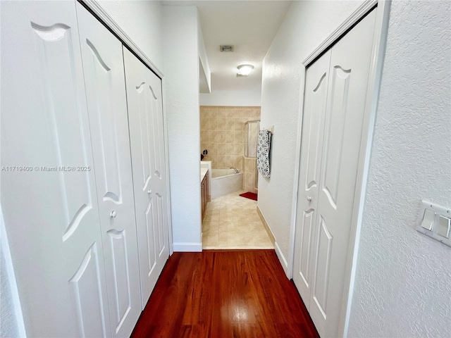 corridor featuring dark hardwood / wood-style floors