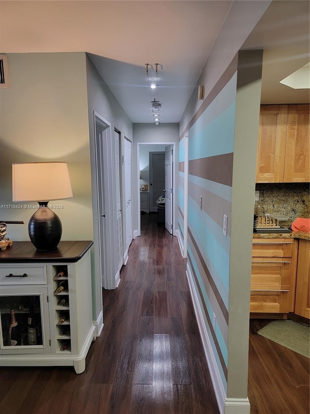 corridor with dark hardwood / wood-style floors