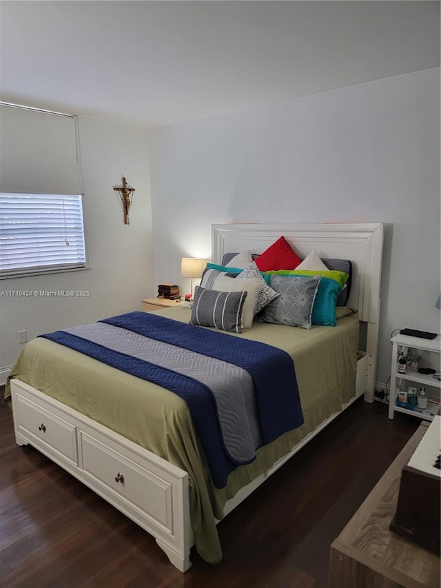 bedroom with dark hardwood / wood-style floors