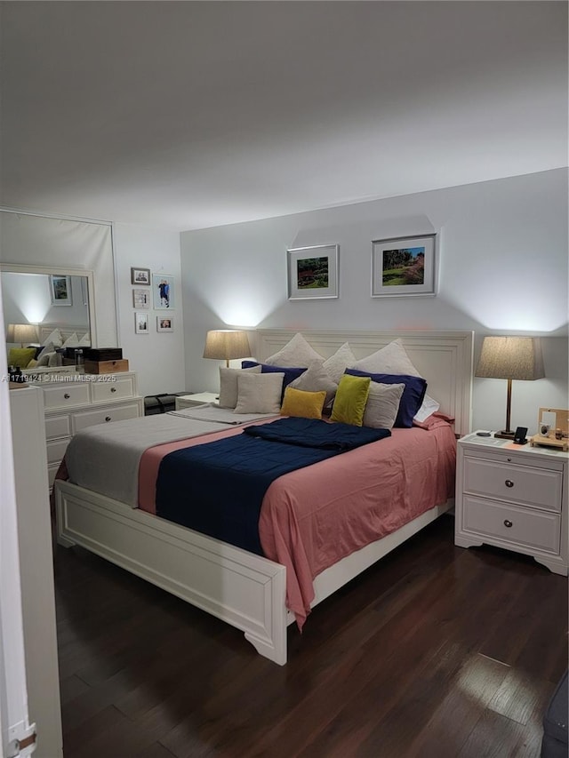 bedroom with dark wood-type flooring