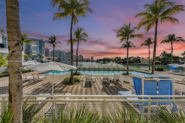 view of pool at dusk