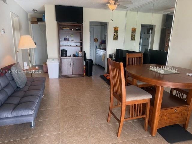 dining space featuring tile patterned flooring and a ceiling fan