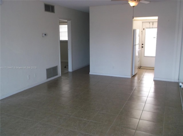 2850 W Golf Blvd Unit 215, Pompano Beach, FL 33064 - empty room featuring ceiling fan, dark tile patterned floors, and baseboards