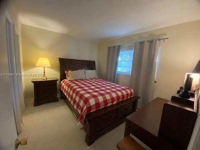 bedroom featuring light carpet