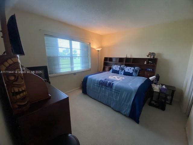 bedroom with carpet and baseboards