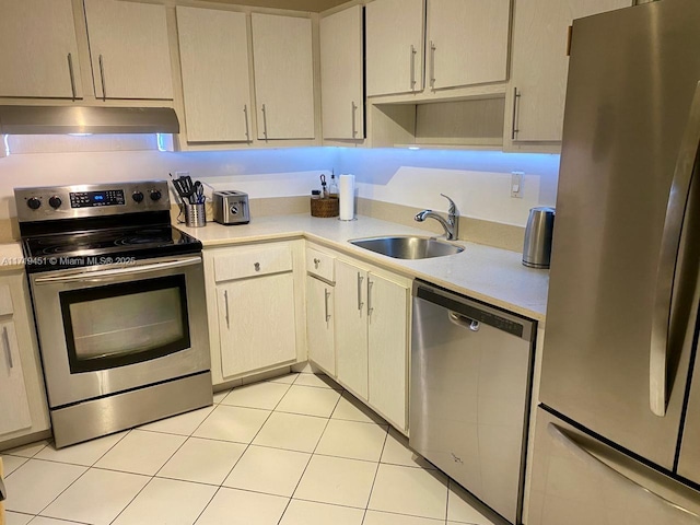 kitchen featuring light tile patterned floors, sink, and appliances with stainless steel finishes