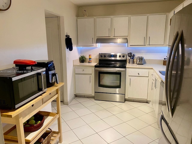 kitchen with light tile patterned floors and stainless steel appliances