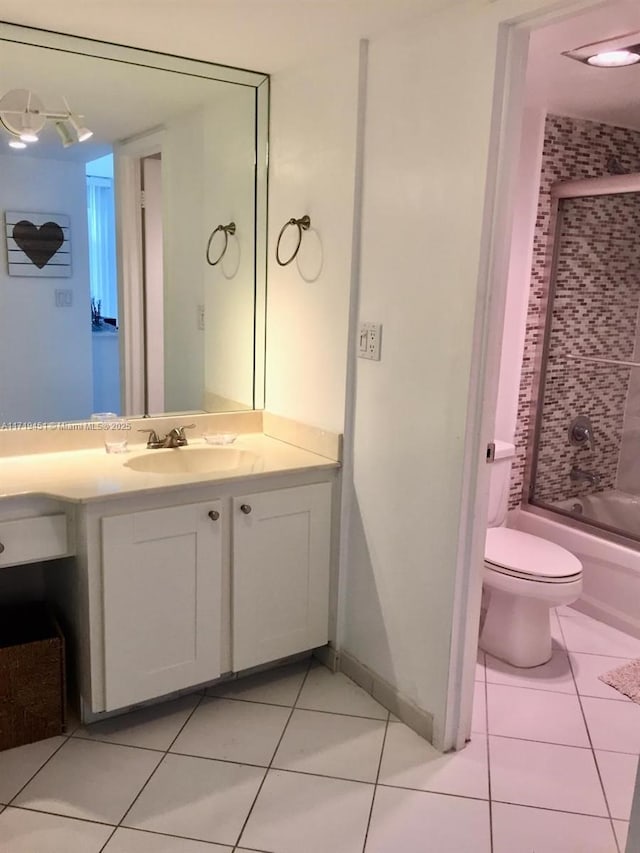 full bathroom with tile patterned flooring, vanity, enclosed tub / shower combo, and toilet