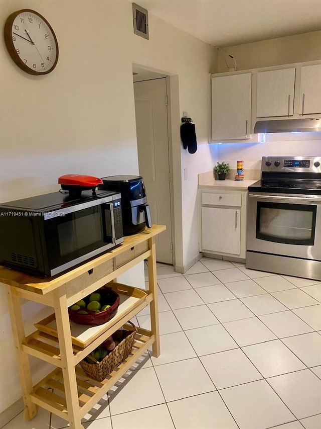 kitchen with light tile patterned floors and appliances with stainless steel finishes