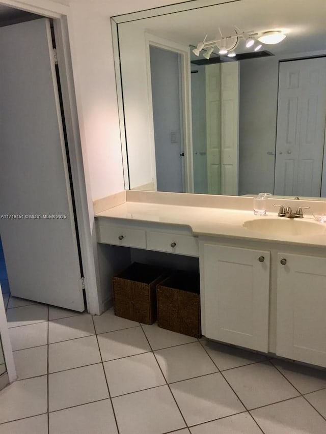 bathroom featuring tile patterned flooring and vanity