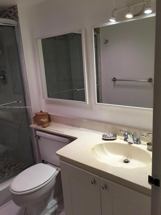 bathroom featuring vanity, toilet, and walk in shower