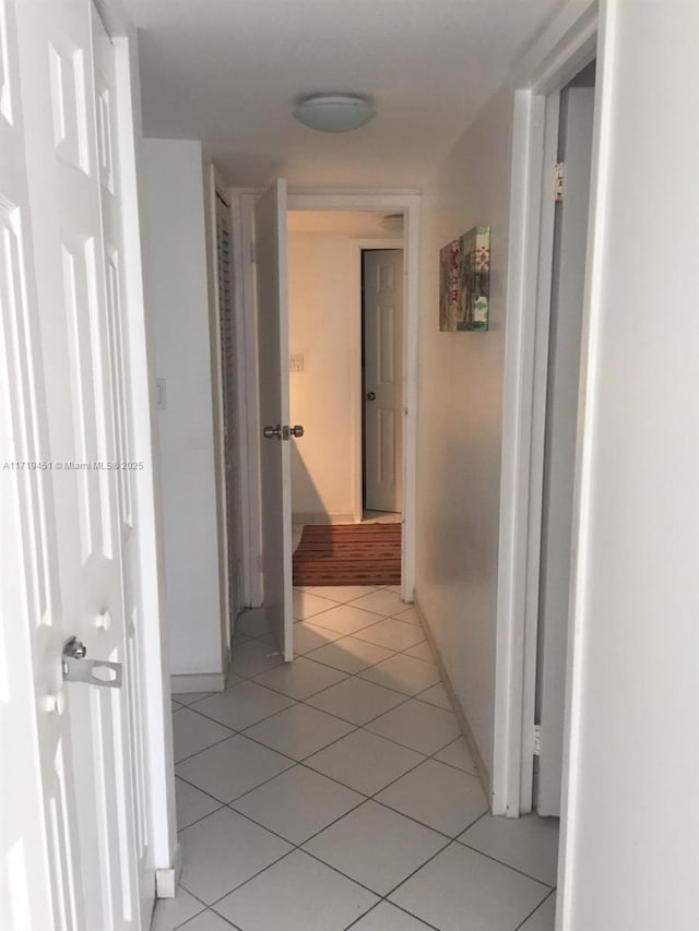 hall with light tile patterned floors