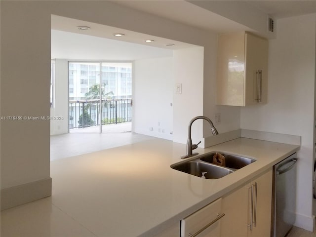 kitchen with dishwasher, a wall of windows, sink, and kitchen peninsula