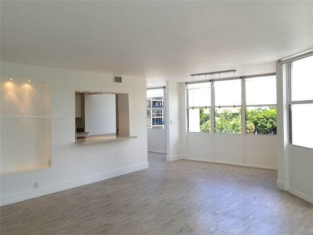 spare room with hardwood / wood-style flooring