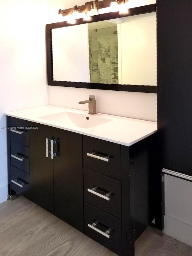 bathroom featuring wood-type flooring and vanity