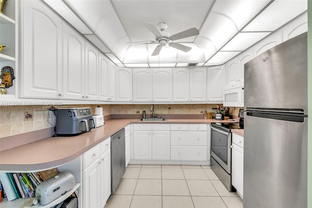 3003 Lyndhurst H Unit 3003, Deerfield Beach, FL 33442 - kitchen featuring appliances with stainless steel finishes, a ceiling fan, light tile patterned floors, and white cabinets