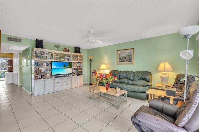 tiled living room with ceiling fan