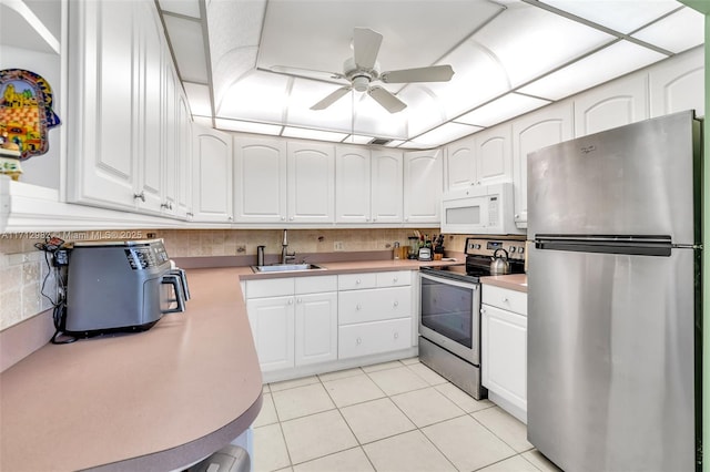 3003 Lyndhurst H Unit 3003, Deerfield Beach, FL 33442 - kitchen with stainless steel appliances, ceiling fan, and white cabinets