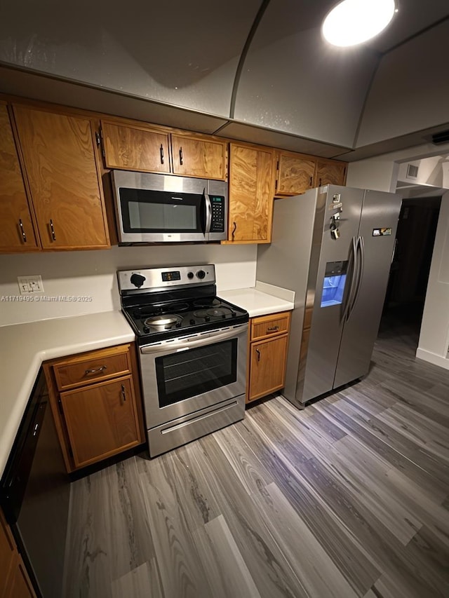 kitchen featuring stainless steel appliances and light hardwood / wood-style flooring