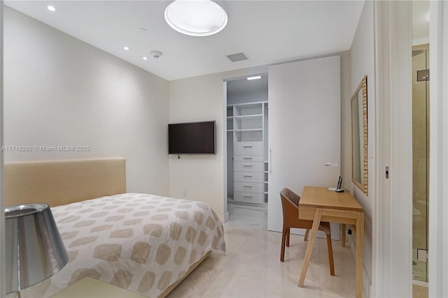 tiled bedroom with a walk in closet and a closet