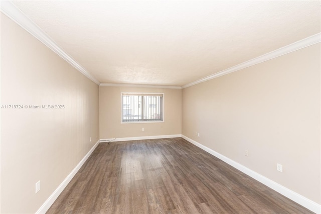 empty room with crown molding and dark wood-type flooring