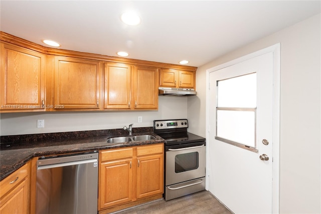 kitchen with dark stone counters, sink, and stainless steel appliances