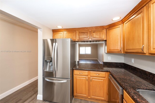 201 Galen Dr Unit 201, Key Biscayne, FL 33149 - kitchen featuring stainless steel appliances, wood finished floors, brown cabinetry, recessed lighting, and dark stone counters