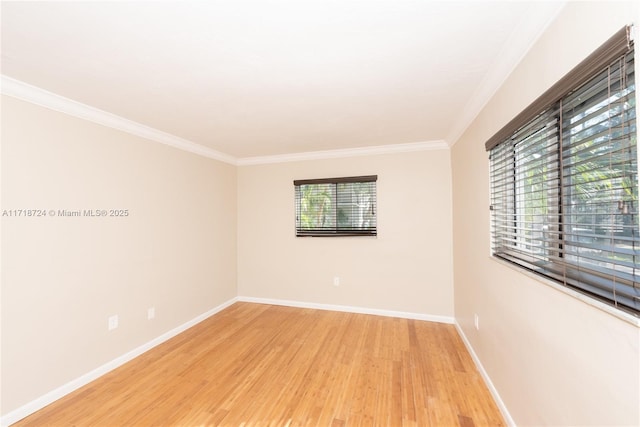 empty room with light hardwood / wood-style floors and ornamental molding