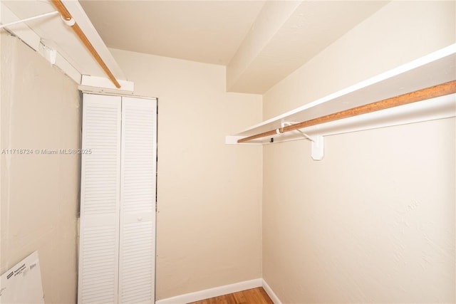 walk in closet featuring hardwood / wood-style flooring