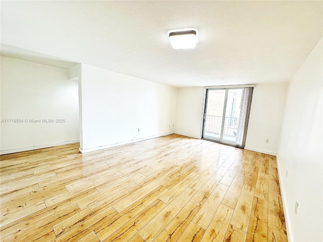 empty room with light hardwood / wood-style floors