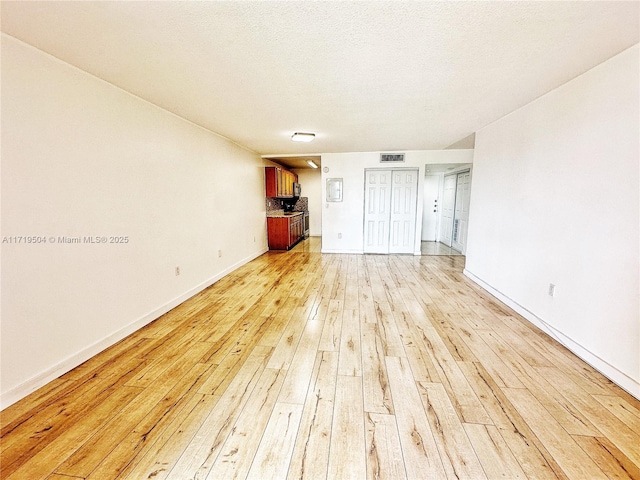 unfurnished bedroom with light wood-type flooring